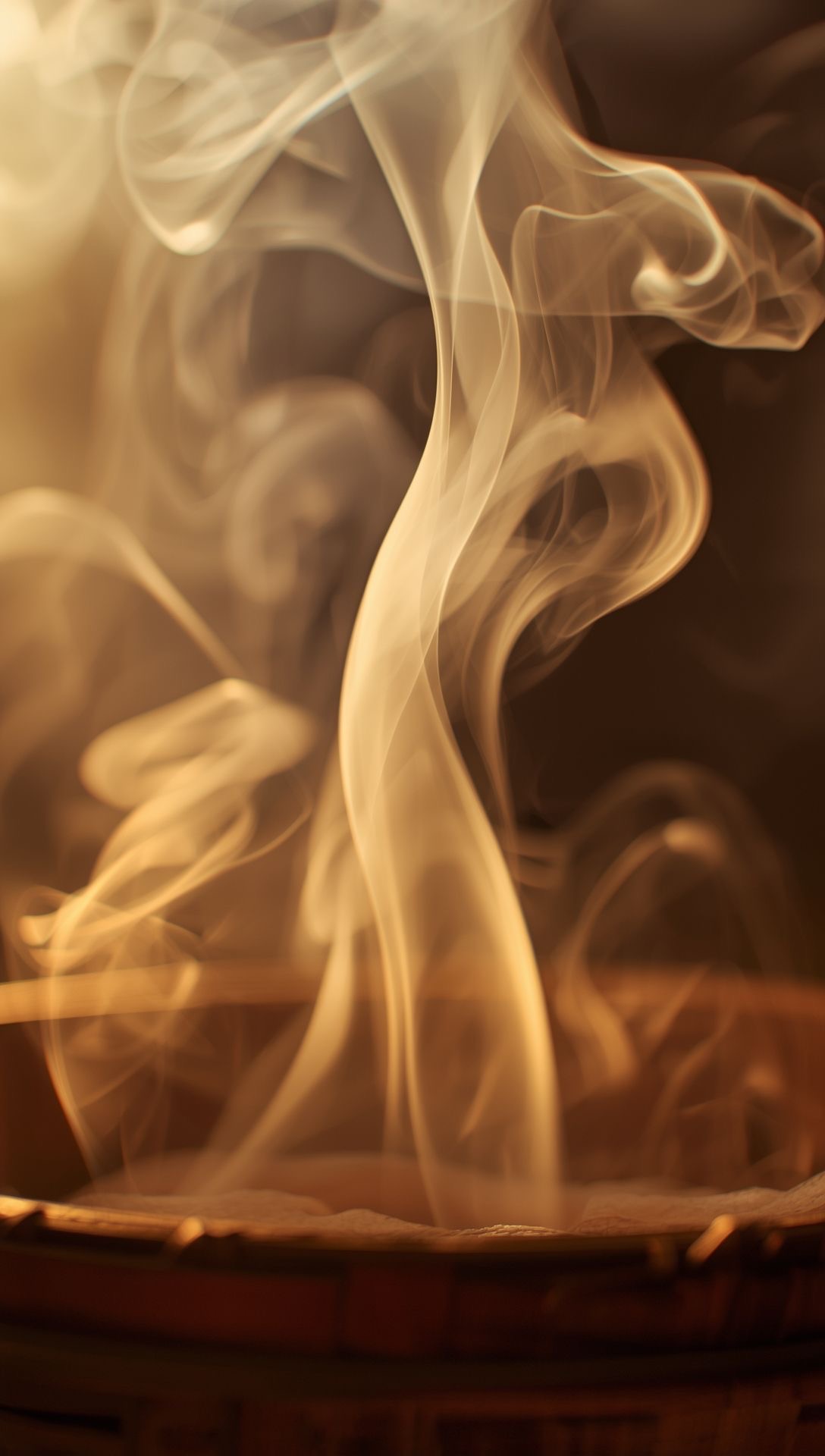 Incense smoke rising from a wooden bowl